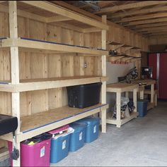 the inside of a garage with shelves and bins