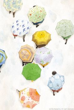 many different colored umbrellas sitting on the ground