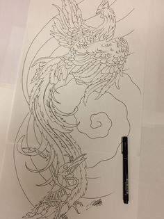 a drawing of a dragon on paper with a pen