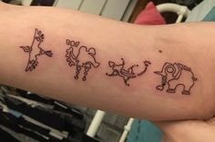 a person with a tattoo on their arm that has three different animals drawn on it