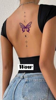 the back of a woman's body with a butterfly tattoo on her lower back