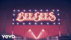 a neon sign that says bee gees on it