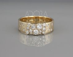 a gold ring with three diamonds on it