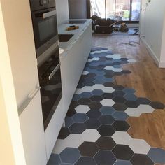 a kitchen with hexagonal tiles on the floor