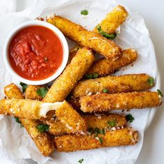 some fried food is on a plate with sauce and ketchup next to it