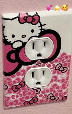 a hello kitty light switch plate cover with pink and white designs on the side,