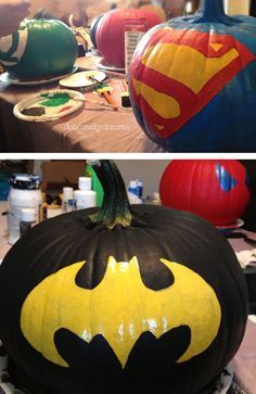 two pumpkins decorated to look like batman and superman logos