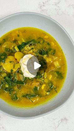 a white bowl filled with soup on top of a table