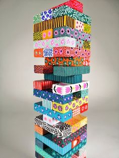 a stack of different colored ribbons sitting on top of each other in front of a gray background