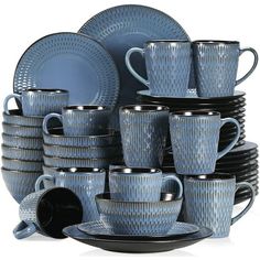 a stack of blue dishes and cups sitting next to each other