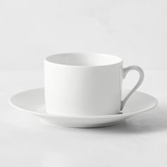 a white coffee cup and saucer on a white background