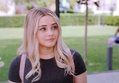 a woman with blonde hair is looking at the camera