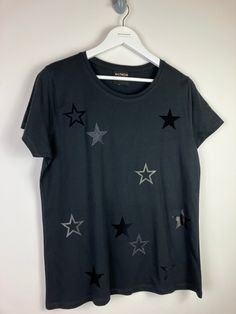 All the stars t-shirt - statement star print - customisable - Handmade  One of our favourite t-shirts which is covered in large stars; a full star and a cut out star, and with two smaller versions placed onto each sleeve. Fully customisable to have matt, metallic, flock or glitter! Matt: white, grey, cherry red, black, navy, green, baby pink, baby blue, raspberry, mint, orange, lemon yellow, lilac, purple Matt Neon: pink, red, yellow, orange, blue, green Metallic: rose gold, matt gold, matt silv Casual Black T-shirt With Star Print, Cheap Fitted Star Print T-shirt, Cotton T-shirt With Star Print For Streetwear, Cotton Short Sleeve T-shirt With Star Print, Cotton Star Print Relaxed Fit T-shirt, Yellow Lilac, Star T Shirt, Penguin T Shirt, Uk Size 16