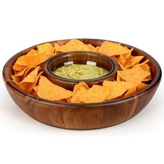 a wooden bowl filled with chips and guacamole