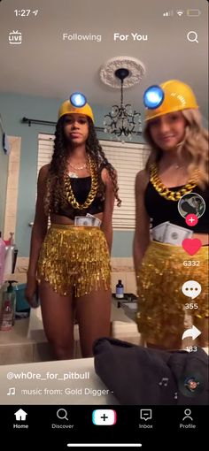 two women wearing gold sequins and matching hats are standing in front of a mirror