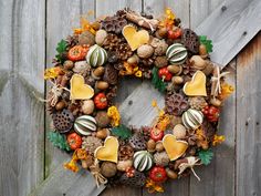 a wreath made out of pine cones, acorns, and other autumn decorations