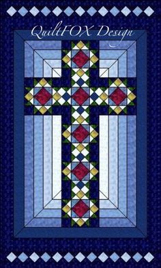 a cross with the words quilt o'design on it