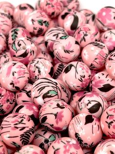 pink and black marble beads with designs on them