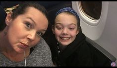 two women sitting next to each other on an airplane