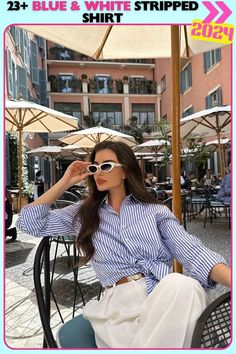 Casual café-style look featuring a blue and white striped shirt paired with loose white pants and gold accessories. The relaxed, flowy fit of the shirt makes it perfect for a leisurely brunch or a day of shopping in the city. Chic Summer Style, Blue And White Shirt