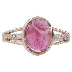 This exquisite cocktail ring showcases a stunning 2.78 carat oval Pink Tourmaline gemstone set in a split shank design with natural earth mined diamonds adding a touch of elegance and sophistication. The gemstone is elegantly framed in a bezel setting. Perfect for making a statement, this ring is both bold and refined. This Pink Tourmaline ring also makes a lovely October birthstone for your loved ones! Specifications Item Type: Ring Center Stone: Pink Tourmaline Treatment: Heated Weight: 2.78ct Head size: 9.8x7.8mm Shape: Oval Hardness: 7-7.5 Metal: 14k/2.47g Diamond Clarity/Color: SI / G-H Diamond Count/Weight: 16/0.11 cttw SKU: AJR1312/1464 This ring is made with solid 14K Gold and natural Earth mined SI / G-H diamonds. As listed, this ring is ready to ship. If you're interested in purc Star Ruby Ring, Pink Tourmaline Ring, Jewelry Safe, Tanzanite Ring, Tanzanite Gemstone, Types Of Gemstones, Modern Ring, Tourmaline Ring, Split Shank