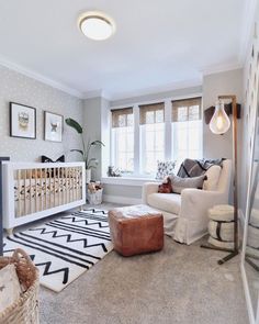 a living room filled with furniture and a baby crib