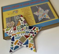 a star shaped ornament sitting on top of a table next to a book