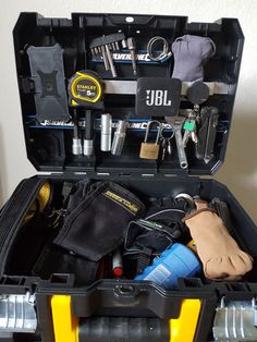 an open tool box filled with tools and other items