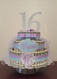 a cake made out of money with the number sixteen on it's tiers