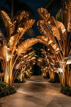 the walkway is lined with palm trees and lit up by street lights at night time