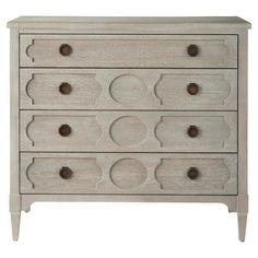 a white dresser with several drawers and knobs