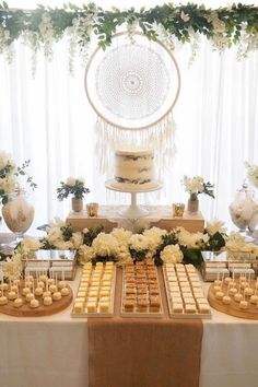 a table topped with lots of desserts covered in white flowers