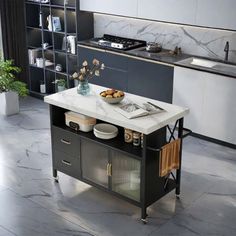 a kitchen with marble counter tops and black cabinets, along with an island in the middle