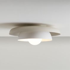 a white ceiling light hanging from the ceiling in a room with no one around it