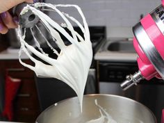 a mixer is being used to make whipped cream