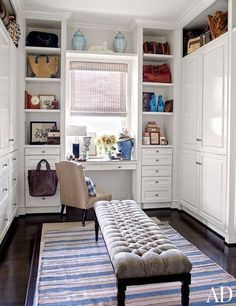 a living room with white cabinets and a blue rug