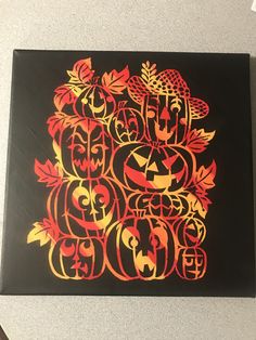 a black and orange painting with pumpkins on it