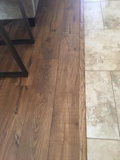 a wood floor that has some kind of tile on it