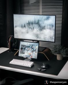 a desktop computer sitting on top of a desk next to a keyboard and headphones