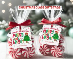 two candy canes wrapped in clear cellophane and tied with red ribbon are sitting next to each other