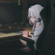 an anime character sitting in front of a computer desk with a keyboard and monitor on it