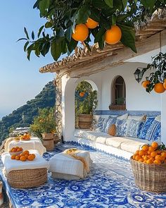 an outdoor seating area with oranges on the table