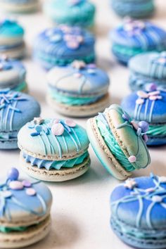 blue decorated macaroons sitting on top of a table