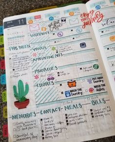 an open planner with stickers on it and a cactus in a pot next to it