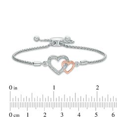 Sure to become an instant favorite, this sparkling diamond accent double heart bolo bracelet celebrates your romance. Crafted in sterling silver The larger heart outline sparkles with diamond accents. A smaller polished heart in precious 10K rose gold entwines with the larger outline. This wheat chain bracelet adjusts to 9.5 inches in length and secures with a bolo clasp and ball ends. Bony Levy Heart Bracelet, Interlocking Hearts, Bolo Bracelet, Heart Outline, Rose Bracelet, Peoples Jewellers, Sparkling Diamond, Double Heart, Bracelet Clasps