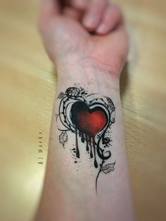 a person with a heart tattoo on their arm