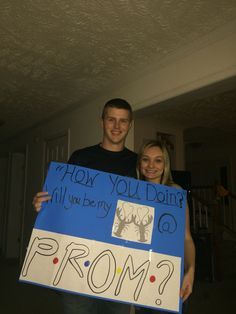 a man and woman holding up a sign that says prom how do you doin?