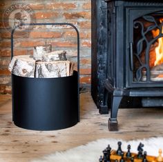 a fire place with logs in it next to a brick wall and wood burning stove