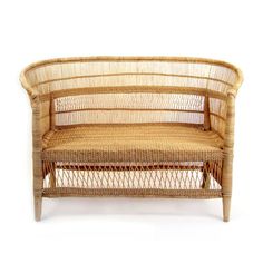 a wicker couch with an armrest made out of wood and woven rattan