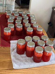 there are many jars on the table with red liquid in them and one is empty